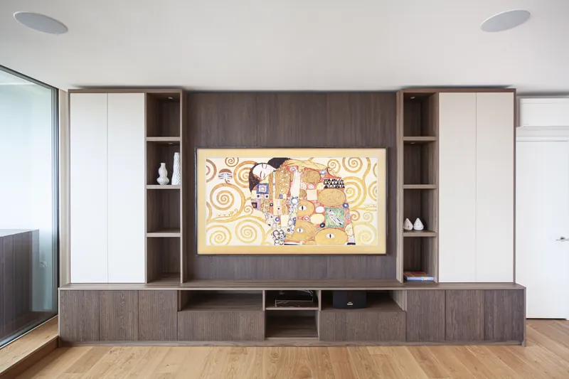 Fluted timber media wall with integrated TV joinery in a London SW1E apartment