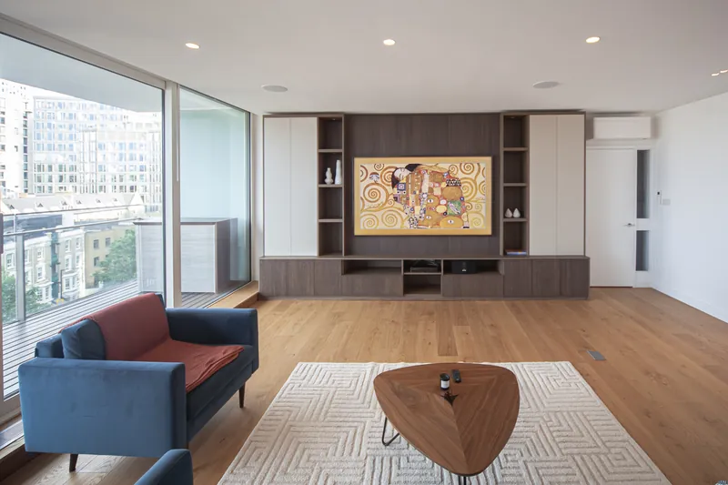 Lounge view of a fluted timber TV wall in a London flat